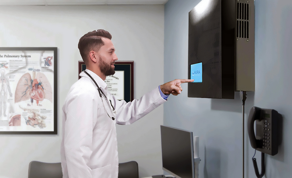 Doctor interacting with an AURA Hygienic unit mounted in a medical facility